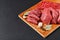 Fresh butcher cut meat assortment on black background