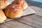 Fresh butter roll bread bun on gunny sack cloth on wooden table