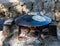 Fresh  cakes are fried on a large Bedouin roasting pan for cooking in camping conditions, heated on an open fire