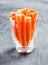 Fresh carrot batons in a glass container