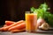 fresh carrot in front of a glass of freshly squeezed juice