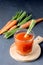 Fresh Carrot Juice in a Glass on a Dark Grey Background Healthy Drink Detox Diet Juice Glass of Tasty Carrot Juice on Wooden Board