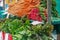 Fresh carrots, parsley and different types of lettuce are sold at the farmer`s market on an autumn day in blue plastic boxes with