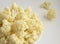 Fresh cauliflower white cabbage divided into inflorescences on a light background