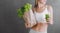 Fresh celery and freshly squeezed celery juice in woman hands