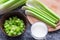 fresh celery sliced into a bowl and a glass of kefir on the table, dietary products