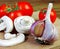 Fresh champignons and ripe tomatoes on a cutting board. Copy spaces.