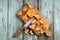Fresh chanterelle mushrooms cut with wooden handle knife on old
