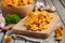 Fresh Chanterelle mushrooms with herbs and spices on rustic wooden background