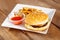 Fresh cheeseburger and potato fries with ketchup on white plate