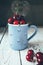 Fresh cherries are in blue mug
