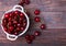 Fresh cherries in a bowl on the wooden table