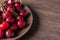 Fresh cherries on a brown plate on a wooden table. Summer food, healthy eating. Organic, vegetarian, vegan, dietary, diabetic