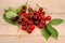 Fresh cherries scattered on a wooden table.