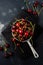 Fresh cherry berries in rustic aluminum pan on dark concrete old background. Top view