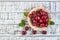 Fresh cherry on plate on wooden blue background