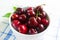 Fresh cherry on plate on wooden white background. fresh ripe cherries. sweet cherries