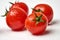 Fresh cherry tomato on white background with waterdrops.