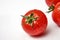 Fresh cherry tomato on white background with waterdrops.