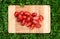 Fresh cherry tomatoes on the old wooden cutting board, closeup food, outdoors shot.