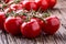 Fresh cherry tomatoes. Ripe tomatoes on oak wooden background