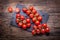 Fresh cherry tomatoes. Ripe tomatoes on oak wooden background