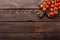 Fresh cherry tomatoes on twigs on wooden table