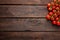 Fresh cherry tomatoes on twigs on wooden table