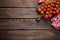 Fresh cherry tomatoes on twigs on wooden table