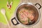 A fresh chicken breast in a pot on the slightly blue glass table