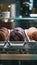 Fresh chocolate cookies in glass showcase at cafe, selective focus