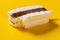 Fresh chocolate and milkshake flavor popsicle with a bite on a yellow background