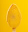 a fresh chocolate outer yellow popsicle on yellow background at vertical composition