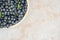 Fresh chokeberry background Aronia melanocarpa on ceramic with copy space