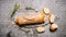 Fresh ciabatta with rosemary on a stone stand.