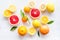 Fresh citrus background. Oranges, grapefruits, leaves - whole fruits and halfs - on white background top-down