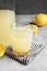 Fresh citrus drink in glassware and lemon on table