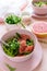 Fresh citrus salad with arugula, grapefruit and sesame seeds on pink background. Selective focus. Raw vegetarian spring detox