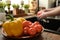 Fresh and clean ripe tomatoes and yellow capsicum on wooden plate