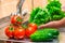 Fresh clean washed vegetables on the background of a kitchen tap