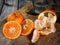 Fresh clementines freshly picked in slices and in wedges on wood