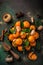 fresh clementines tangerines with spices on dark greeen backgroun