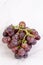 Fresh cluster of grapes on the grey marble