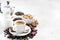 fresh coffee, chocolates and sweets on white background