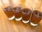 Fresh cold Apple juice in four clear glass with wooden background