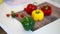 Fresh and colorful bell peppers and other vegetables on cutting board