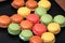 Fresh colorful macaroons taken out of the oven and empty space for text