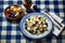 Fresh and Colorful Mediterranean Salad on a Rustic Blue and White Checkered Tablecloth, ai generative