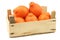 Fresh and colorful  Minneola tangelo fruit in a wooden crate