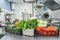 Fresh colorful Vegetables and fruit in kitchen on silver steel table. Work surface and kitchen equipment in professional